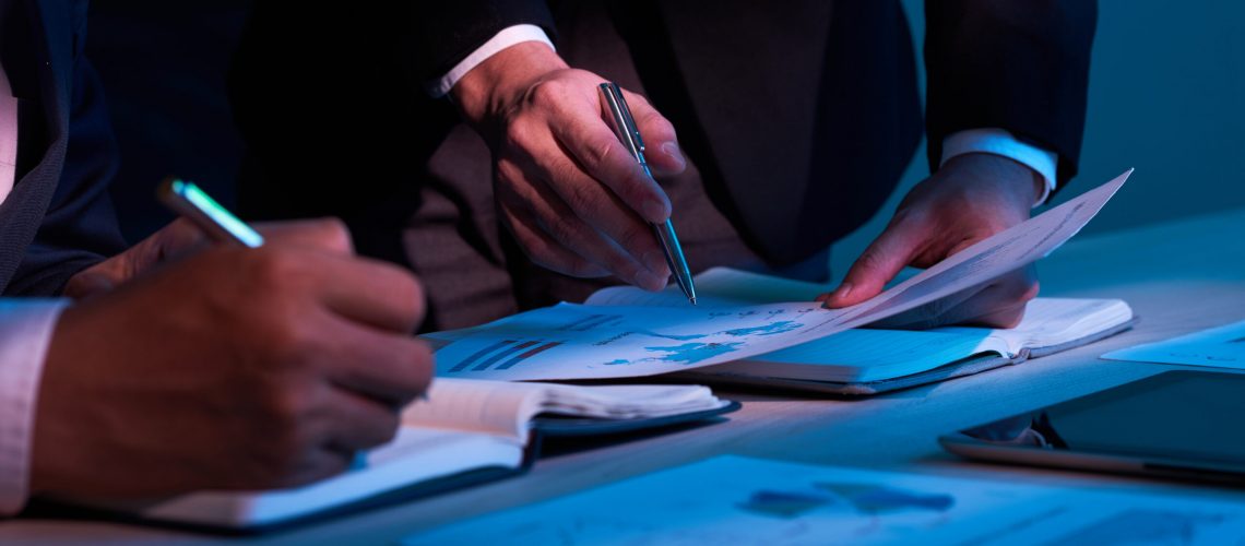 Close-up image of business partners working with financial documents