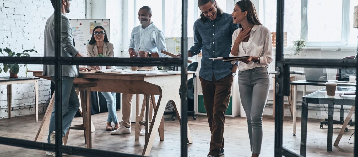 Quick meeting. Full length of business people working and communicating while spending time in the office